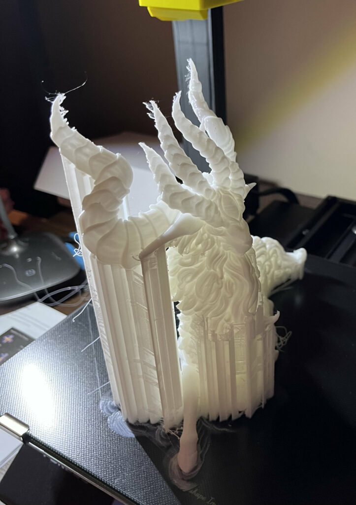 photograph of a 3d printed object with supports still attached